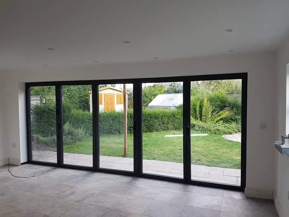 Bi-fold doors opening from a new extension onto the garden