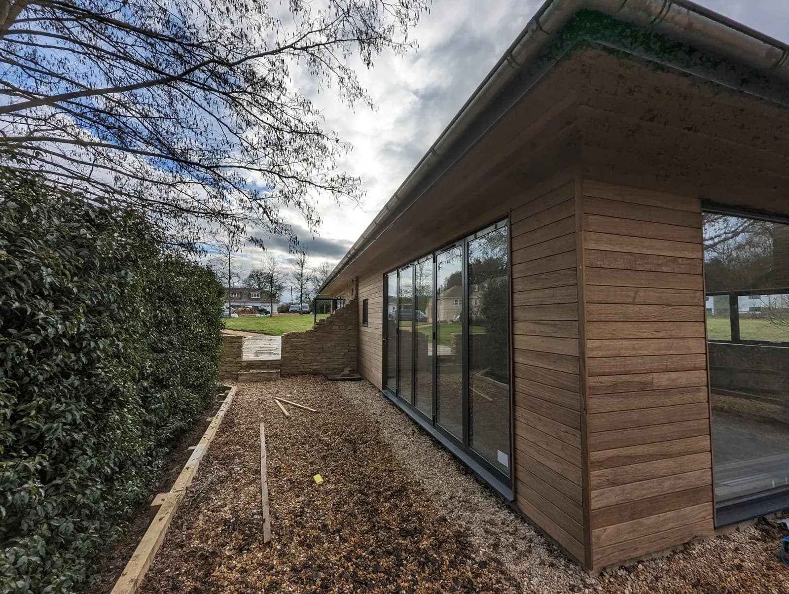 Cedar-clad garden building with floor-to-ceiling glazing